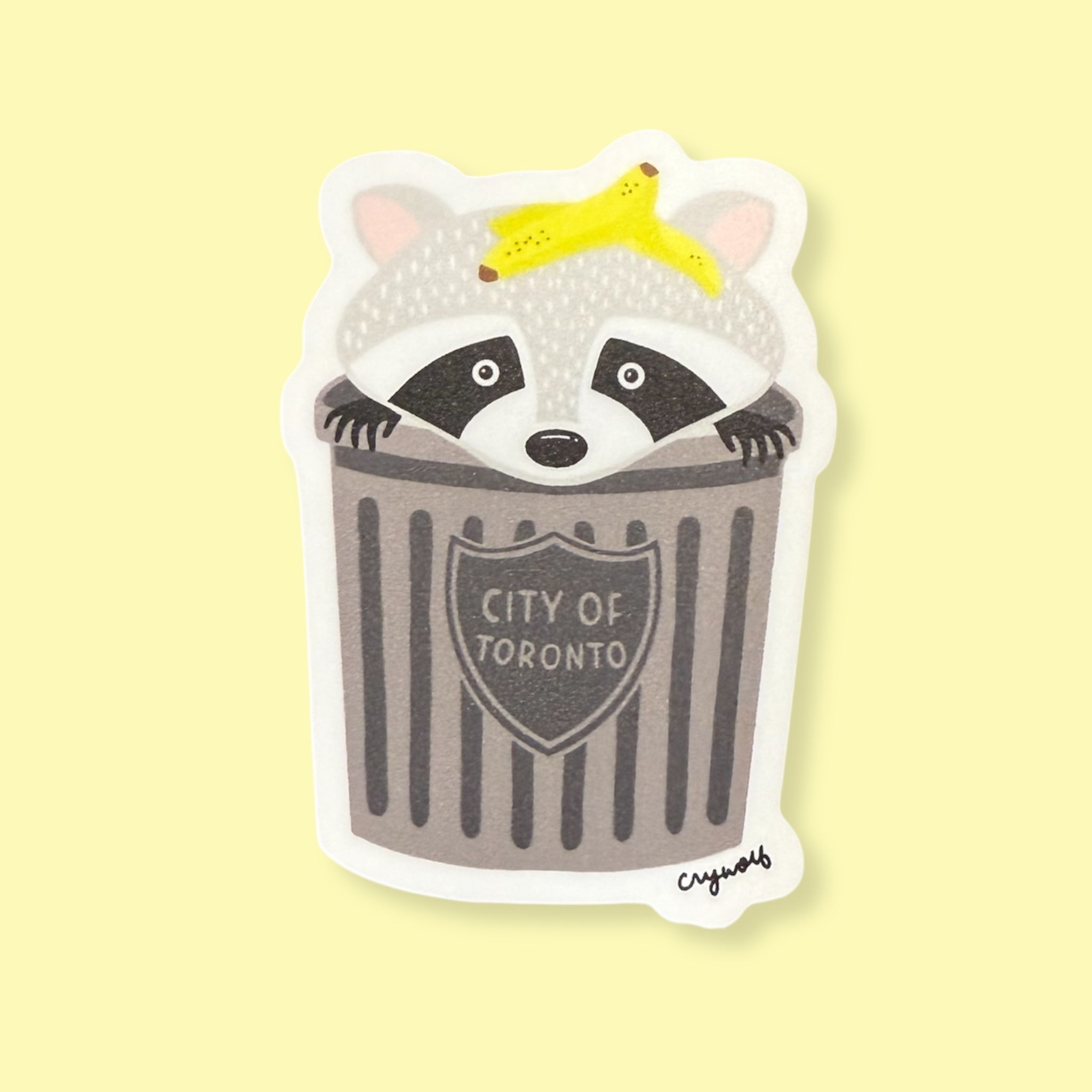 Sticker of a raccoon in a trash can with 'City of Toronto' text on a yellow background